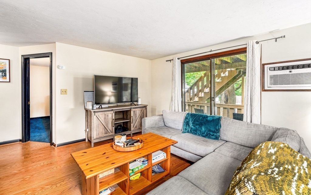 30 Pope Street, Unit A Hudson, MA 01749 - Photo 4 of 9 a living room with furniture and a flat screen tv