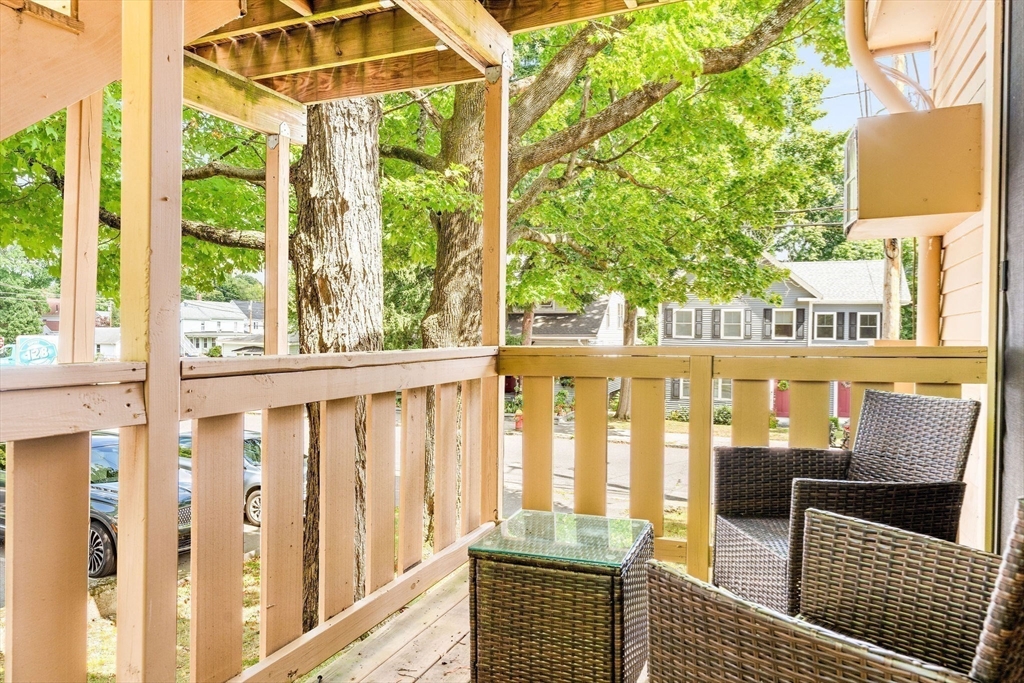 30 Pope Street, Unit A Hudson, MA 01749 - Photo 7 of 9 a view of a balcony with wooden floor and outdoor space