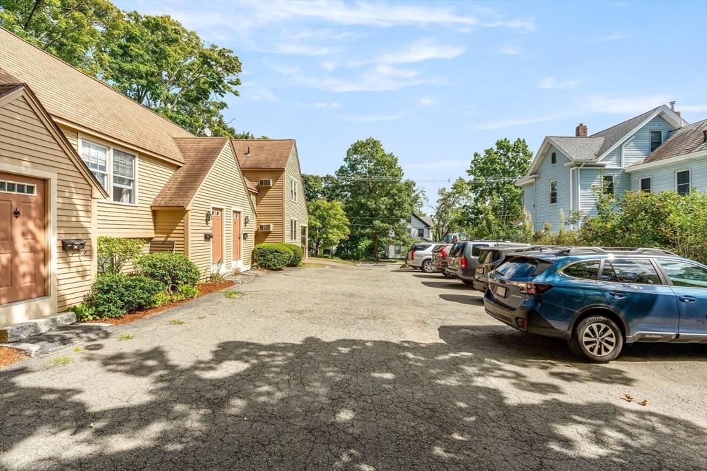 30 Pope Street, Unit A Hudson, MA 01749 - Photo 8 of 9 a car parked in front of a white house