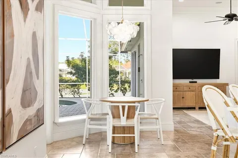 a dining room with furniture and window