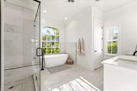 a spacious bathroom with a tub and shower
