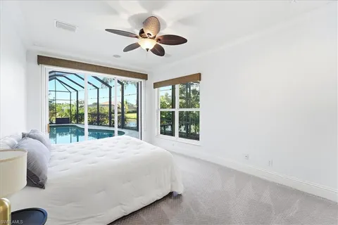a large bed sitting in a bedroom next to a window