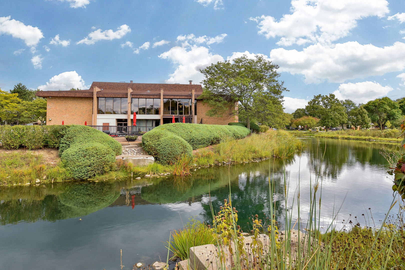 478 Raintree Court, Unit 2B Glen Ellyn, IL 60137 - Photo 11 of 16 a view of a lake with a building in the background