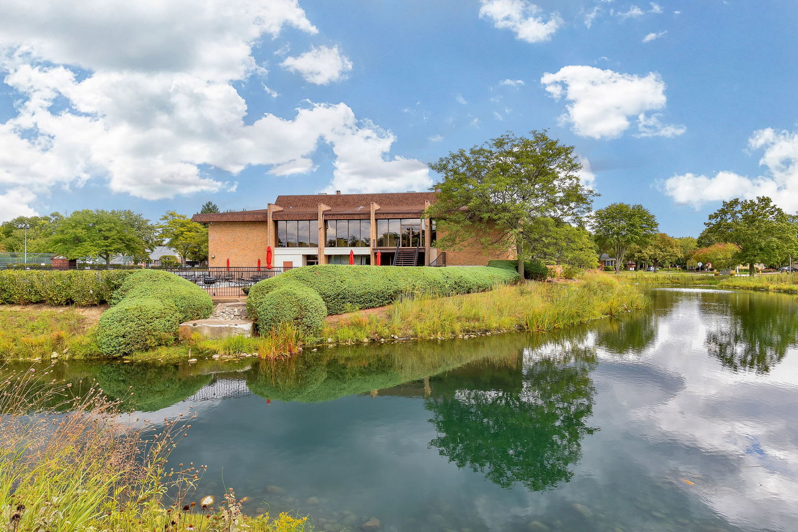 478 Raintree Court, Unit 2B Glen Ellyn, IL 60137 - Photo 16 of 16 a view of a lake with a building in the background