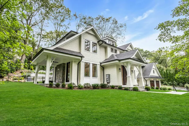 a front view of a house with a garden and plants