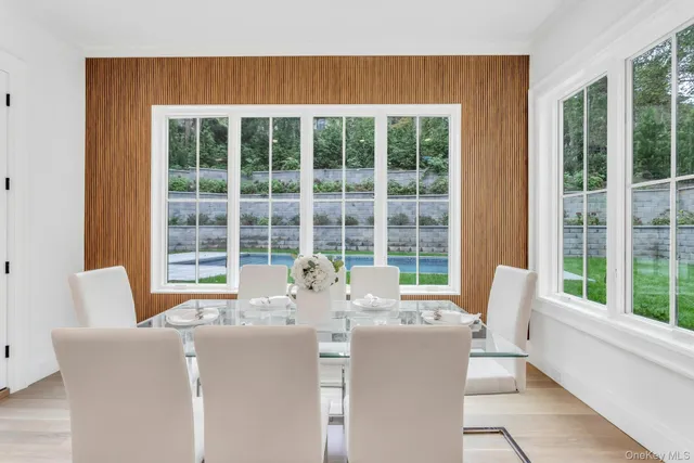 a view of a dining room with furniture a rug and wooden floor