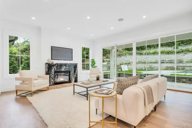 a living room with fireplace furniture and a flat screen tv