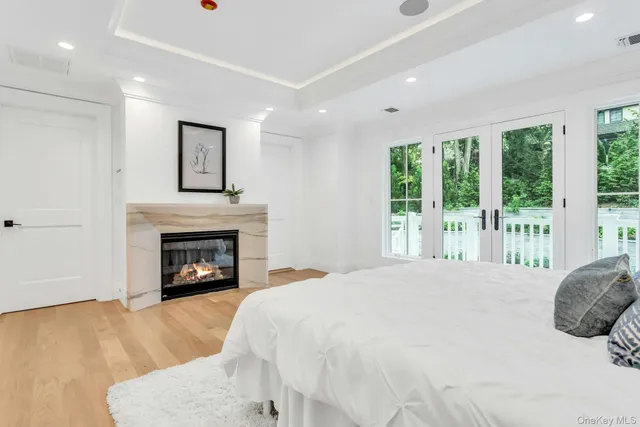 a spacious bathroom with a double vanity sink a mirror and a bathtub