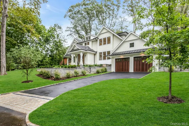 a front view of a house with a garden and yard