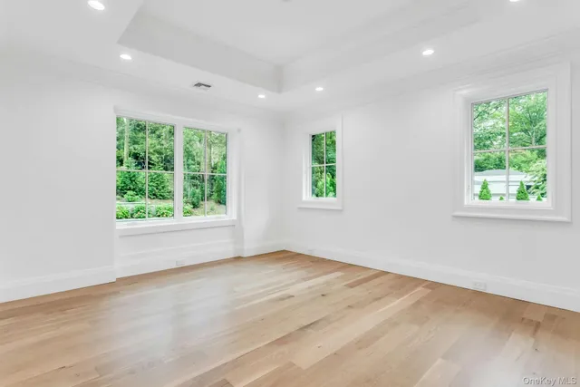 an empty room with closet and windows