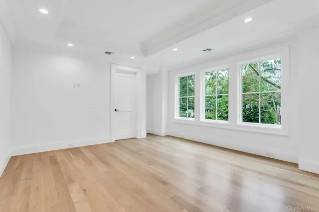 a bathroom with a granite countertop toilet sink and mirror