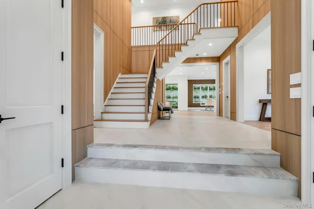 a view of entryway and hall with wooden floor