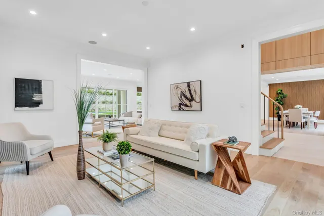 a living room with furniture a flat screen tv and a table