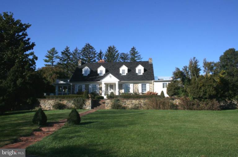 a front view of a house with a garden and yard
