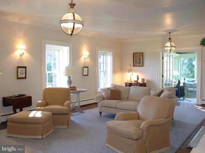 40694 Farm Market Road Leesburg, VA 20176 - Photo 13 of 30 a living room with furniture chandelier and a large mirror