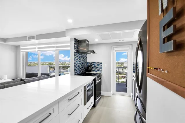 a bedroom with a large bed and a flat tv screen on dresser