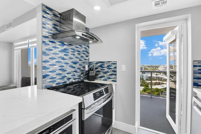 a living room with fireplace furniture and a large window