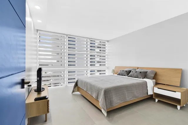 a bathroom with a double vanity sink toilet mirror and shower