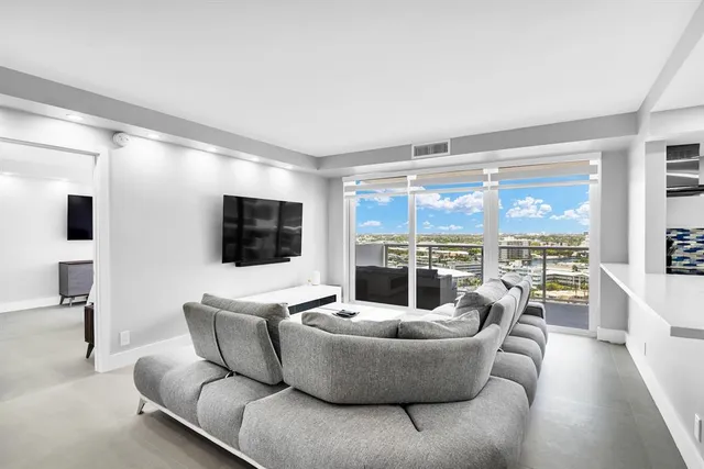 a living room with couches and a flat screen tv