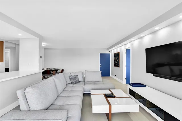 a view of a dining room with furniture and a chandelier fan