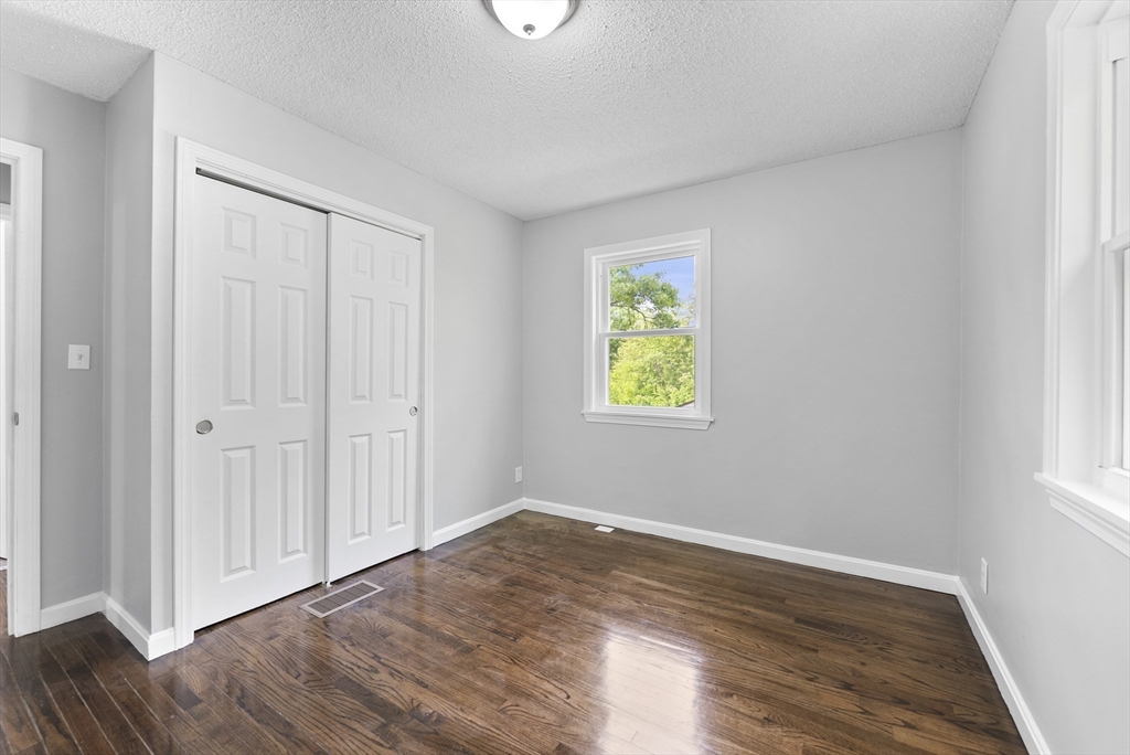 68 Crestmont Street Springfield, MA 01108 - Photo 15 of 35 an empty room with wooden floor and window