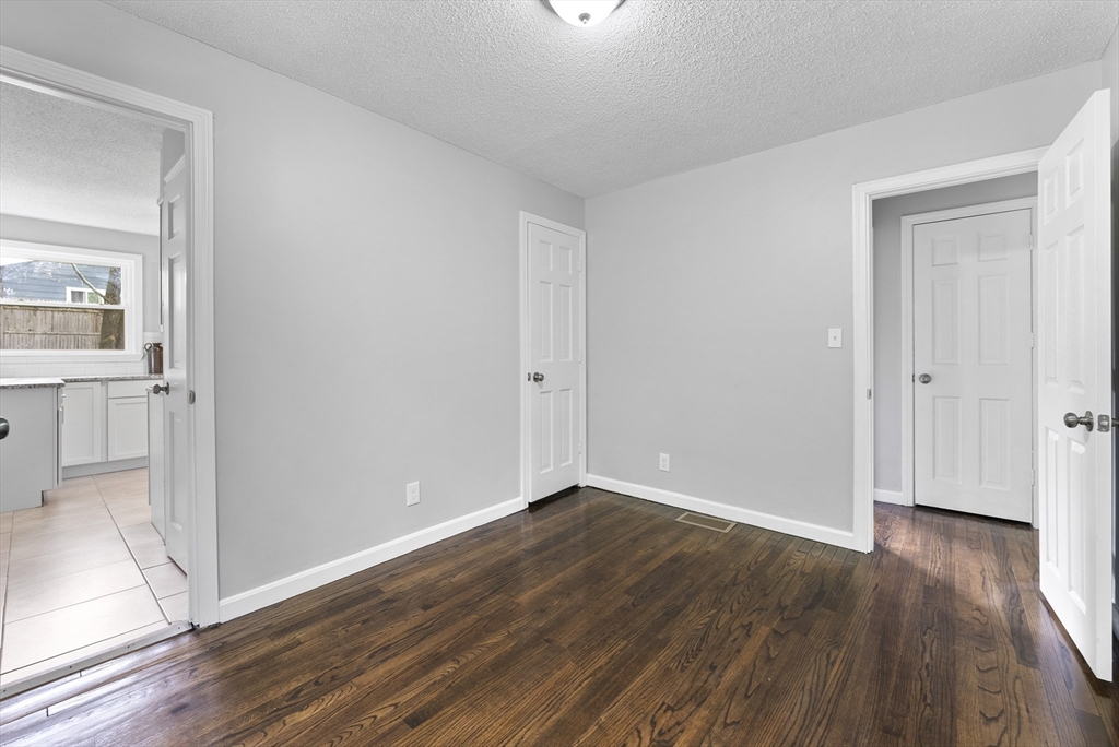 68 Crestmont Street Springfield, MA 01108 - Photo 17 of 35 an empty room with wooden floor & windows