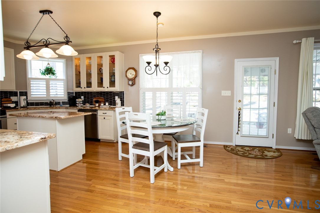 110 Jesse's Way Farmville, VA 23901 - Photo 14 of 56 a kitchen with stainless steel appliances kitchen island granite countertop a stove a sink and white cabinets with wooden floor