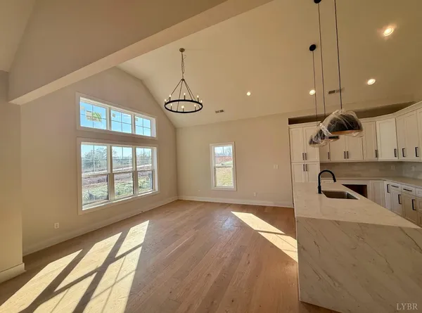 a kitchen with stainless steel appliances granite countertop a sink a stove and a window