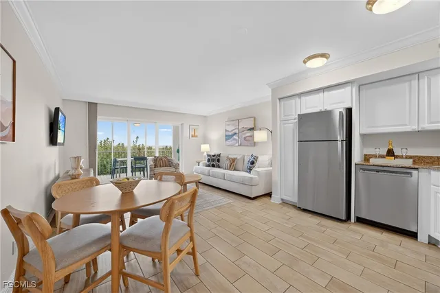 a dining room with furniture and a kitchen view
