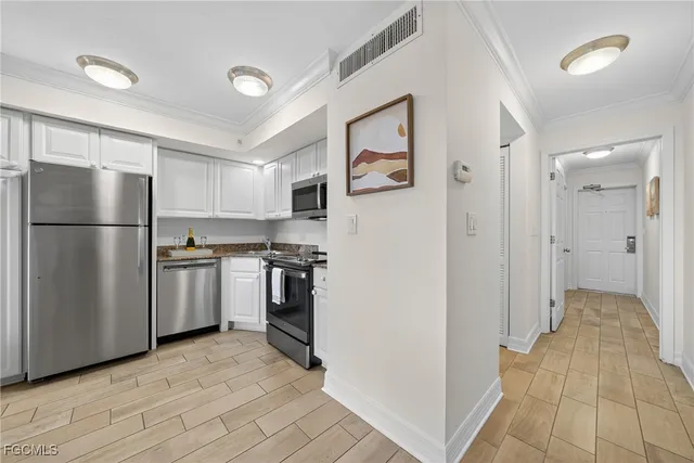 a kitchen with a refrigerator and a sink