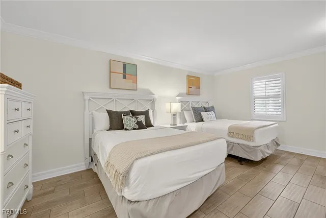 a bedroom with two beds and a window