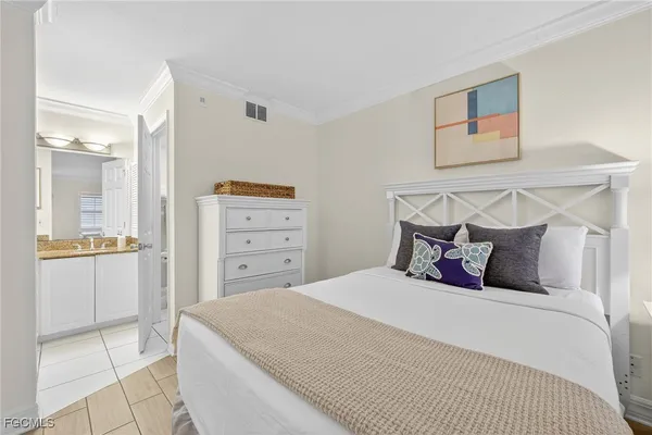 a bedroom with a bed and cabinet