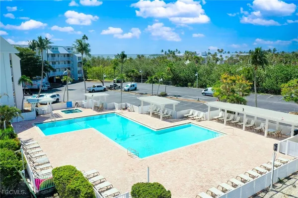a view of a swimming pool with outdoor seating and a patio