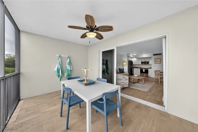 a view of a dining room with furniture and a chandelier