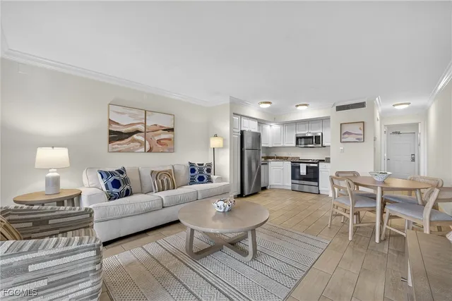 a living room with furniture a view of bedroom and a window