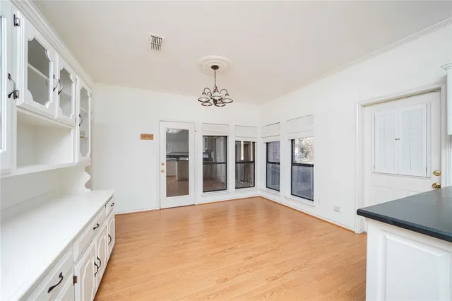 a view of an empty room with chandelier