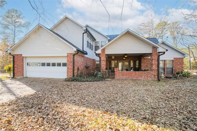 a view of a house with a yard next to a road