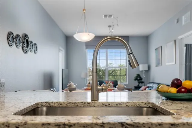 a view of a kitchen counter space a sink and a window