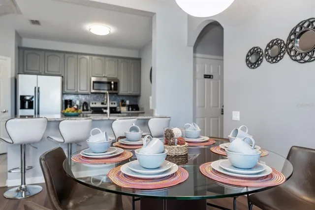 a kitchen with a table and chairs