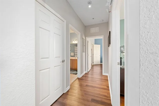 a view of a hallway with wooden floor