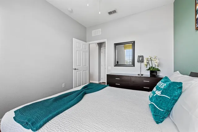 a bedroom with a bed window and wall painting