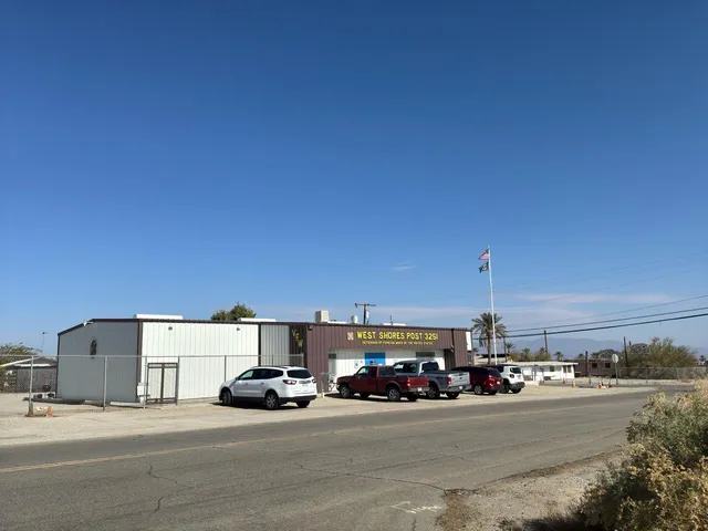 a view of a city street with a car parked on the road