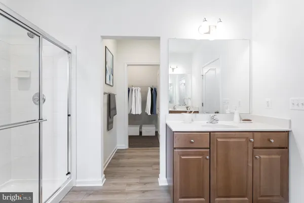 a bathroom with a double vanity sink mirror and shower