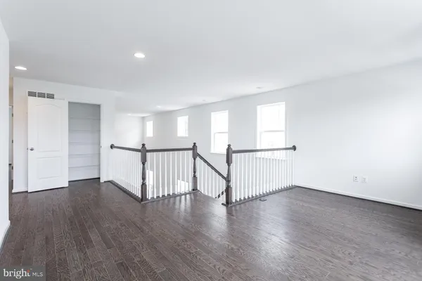 an empty room with wooden floor