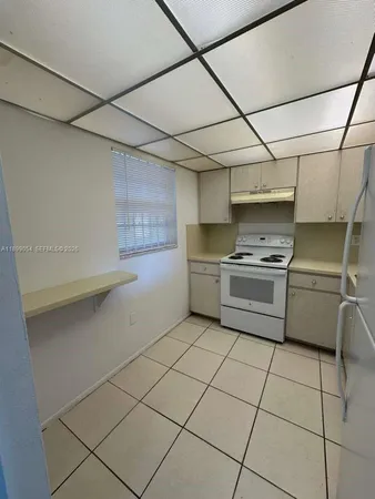 a kitchen with stainless steel appliances a sink and a refrigerator