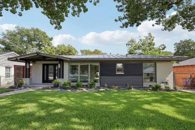 a front view of house with yard and outdoor seating