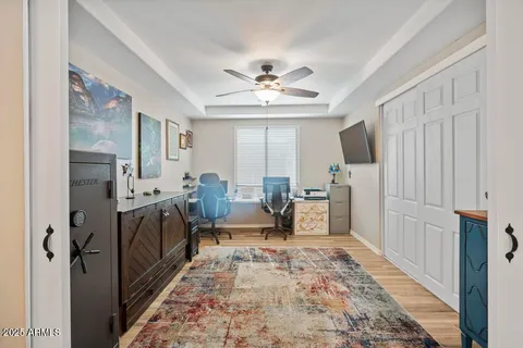 a living room with furniture a large window and wooden floor