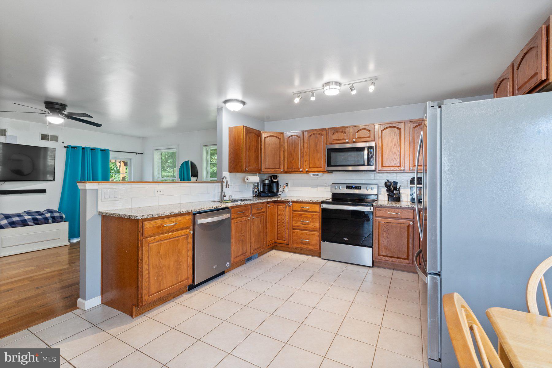 1903 Hain Road New Freedom, PA 17349 - Photo 16 of 40 a kitchen with stainless steel appliances granite countertop a refrigerator stove top oven and sink