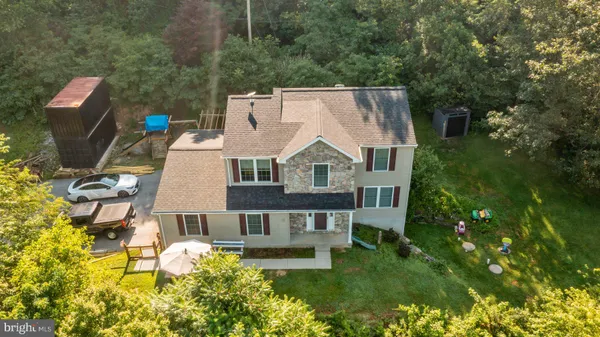 a aerial view of a house with swimming pool garden and patio