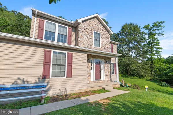 a front view of a house with a yard